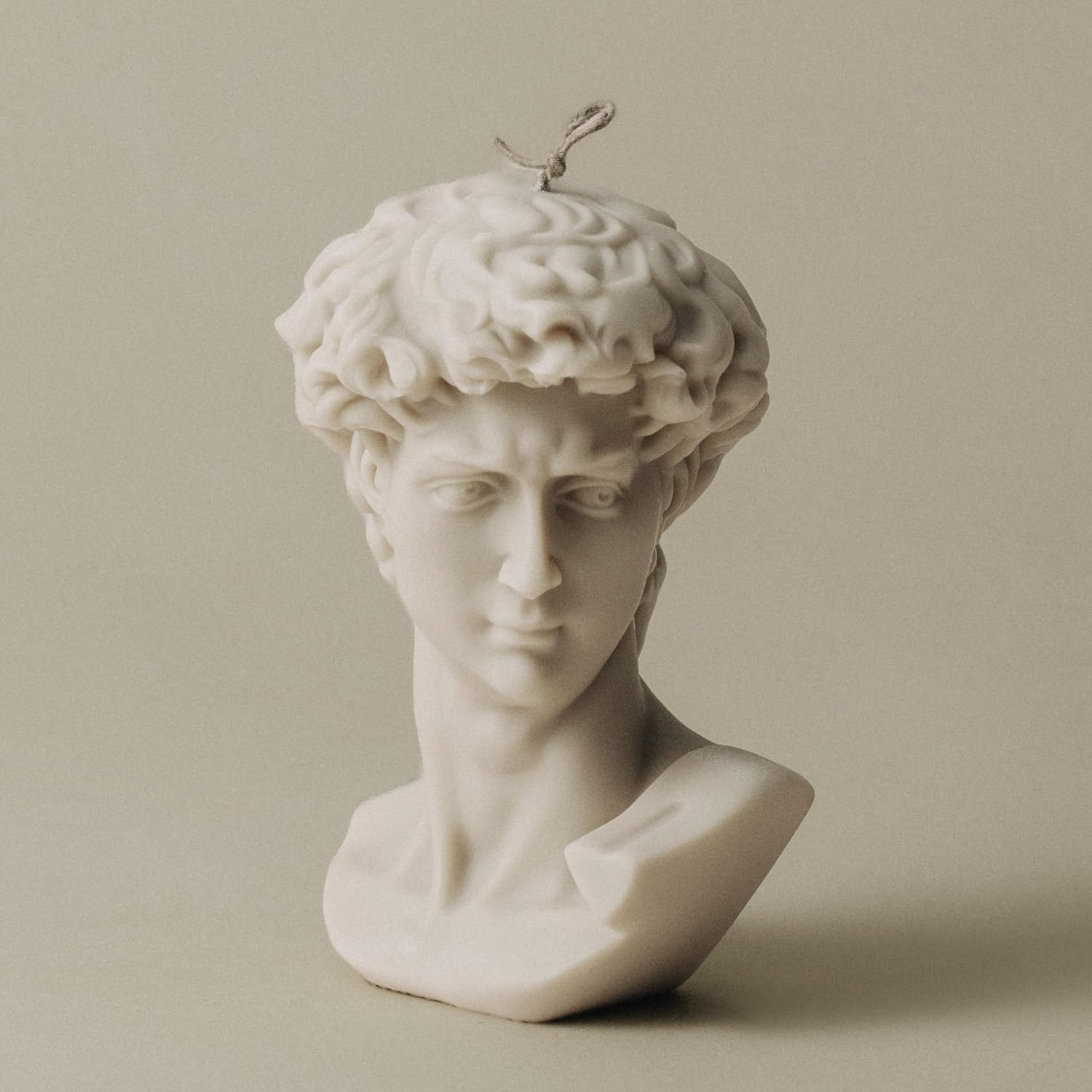 Actual LAWA David Bust candle in Moon Gray wax, with detailed curls, a sculpted face and an unlit wick.