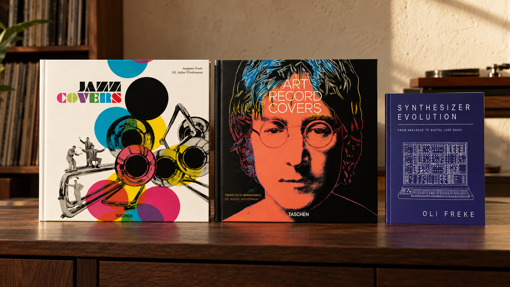Jazz Covers and Art Record Covers square hardcovers beside the smaller Synthesizer Evolution paperback on a walnut console in a listening room. AI-assisted editorial arrangement.